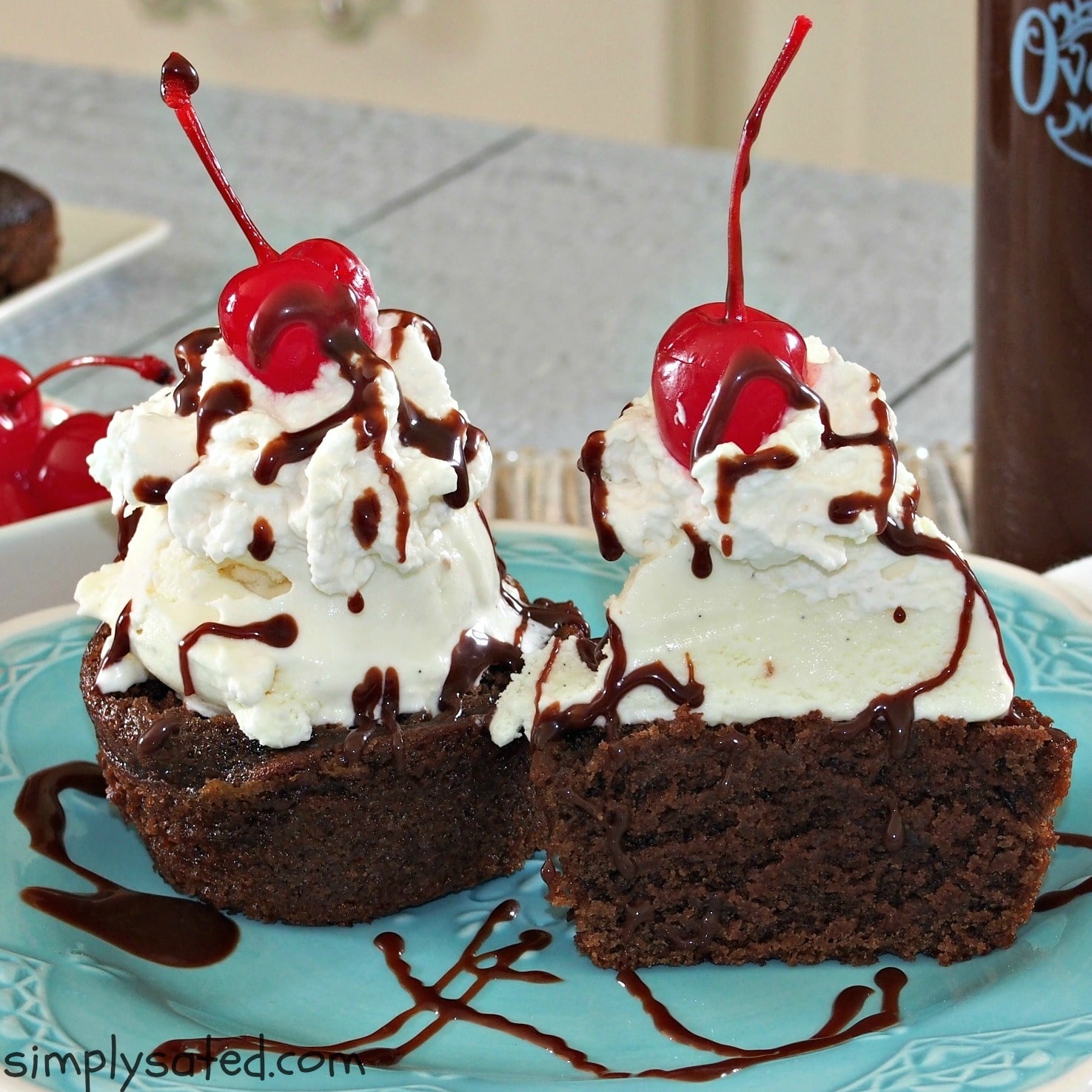 Beautiful and yummy! Dessert can't get better than this gorgeous Hot Fudge Sundae Cupcake with layers of chocolate cake, ice cream, homemade hot fudge sauce, whipped cream with a cherry on top. www.simplysated.com