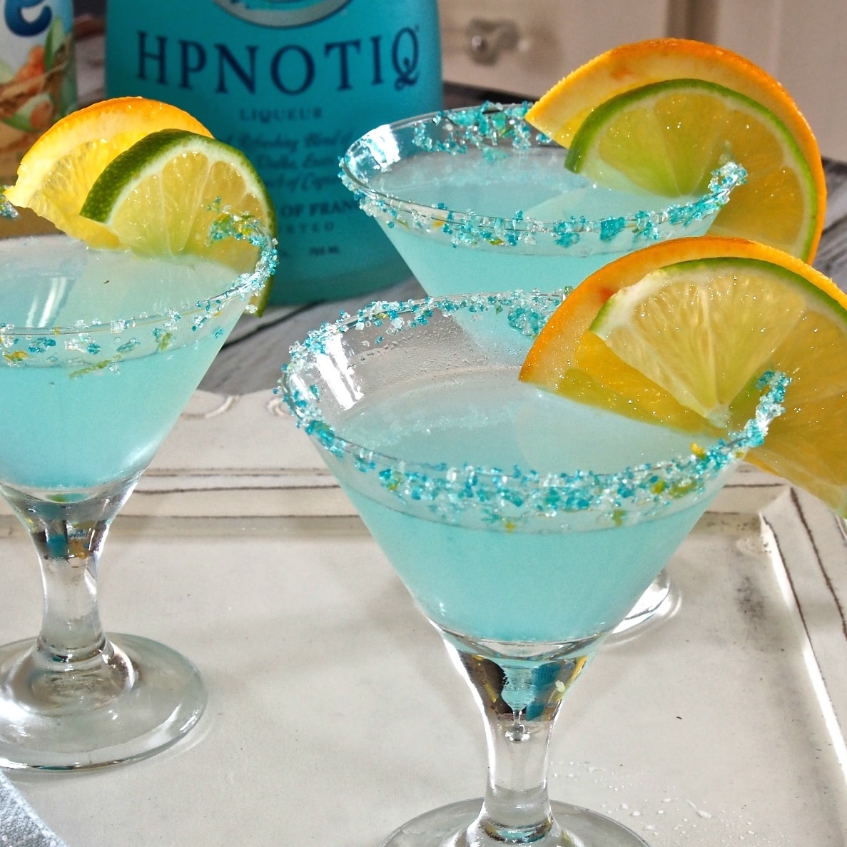 Opal Sky Cosmo is sky blue has hints of lime, orange, cranberry with Hypnotiq Liqueur taking center stage.