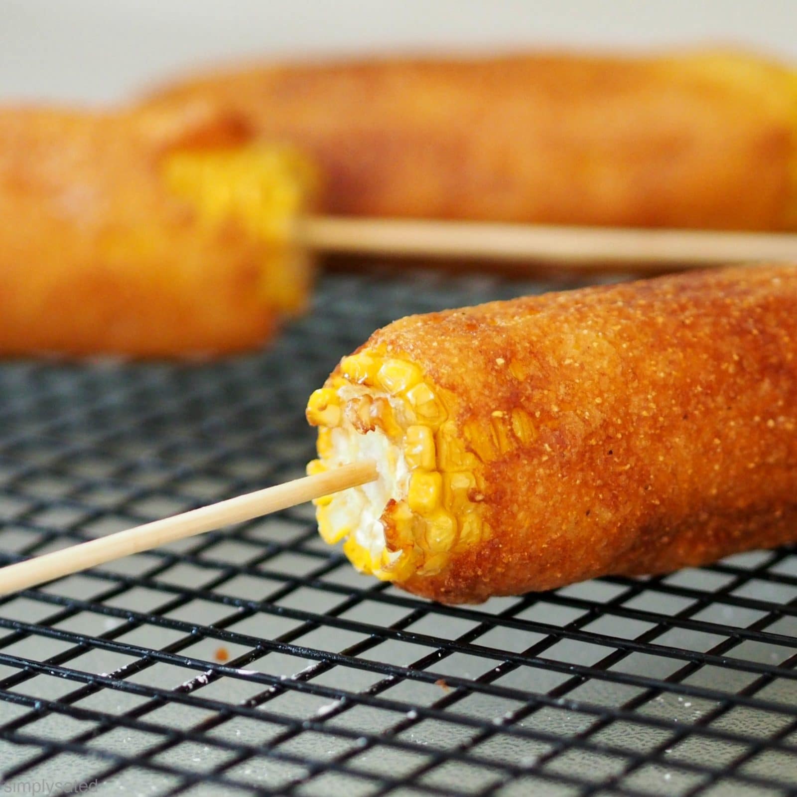 Batter Fried Corn-on-the-Cob is the marriage of the corn dog and corn-on-the-cob and is surprisingly delicious. www.simplysated.com