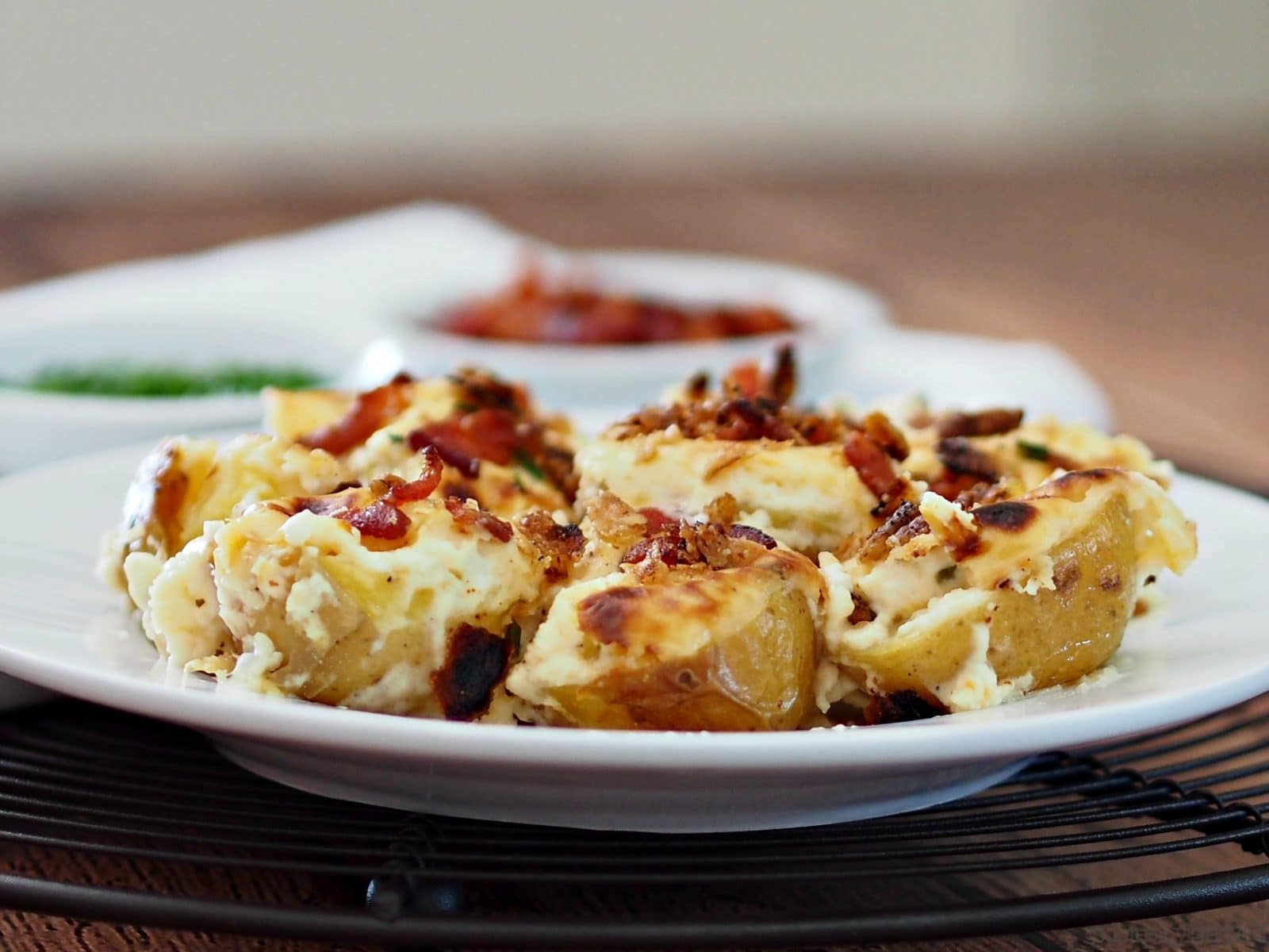 Loaded New Potato Casserole - roasted new potatoes combined with cheese, chives, sour cream and bacon. Serve as a side or a beautiful appetizer.