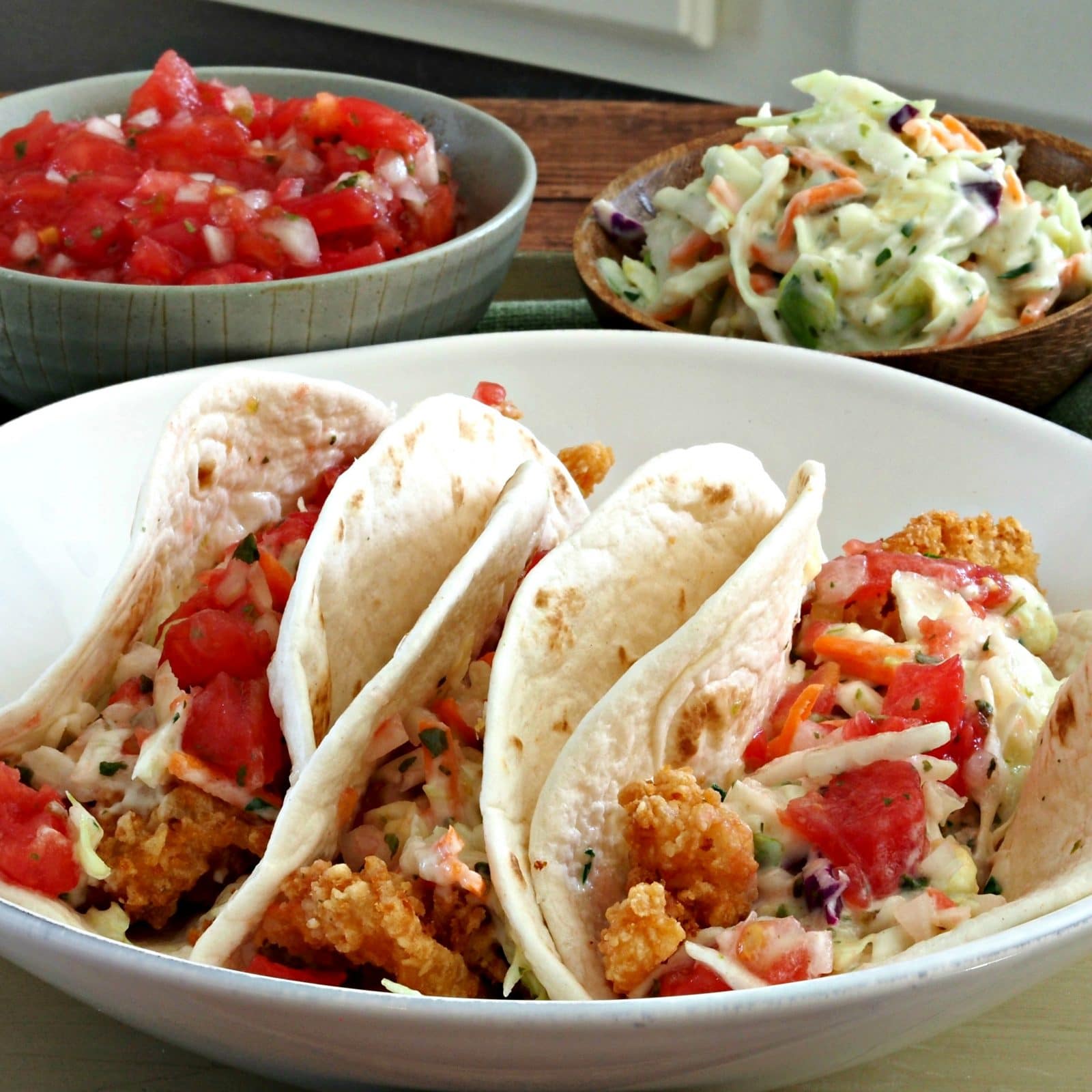 Popcorn Shrimp Tacos with Coleslaw & Pico de Gallo is packed with flavor and textures.  A dish you will make again and again.  