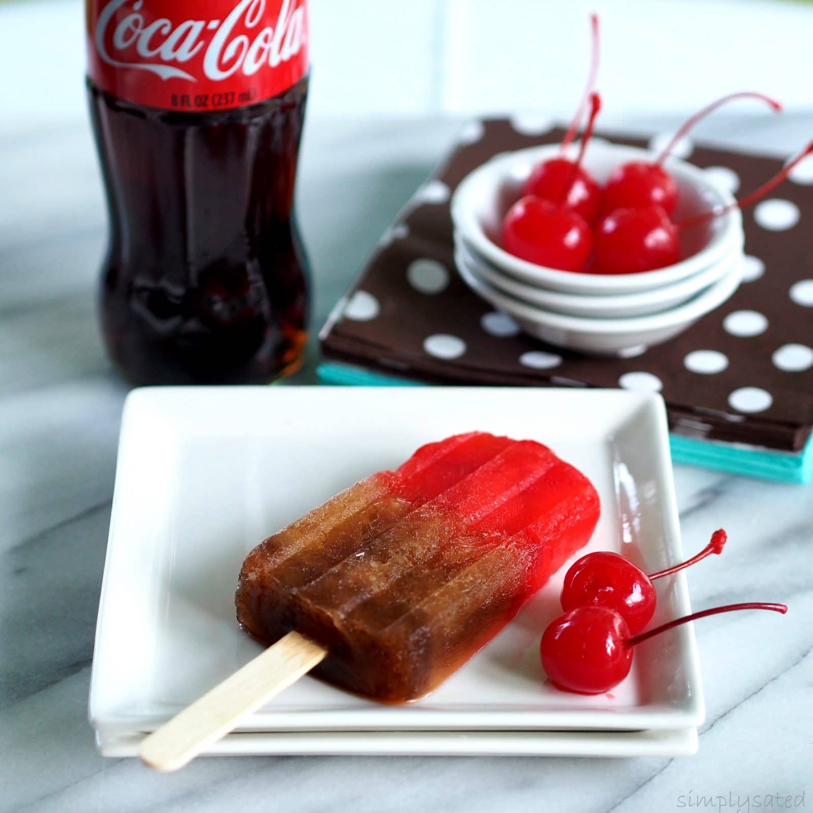 Cherry Coke Popsicles are a fun take on the real thing. www.simplysated.com