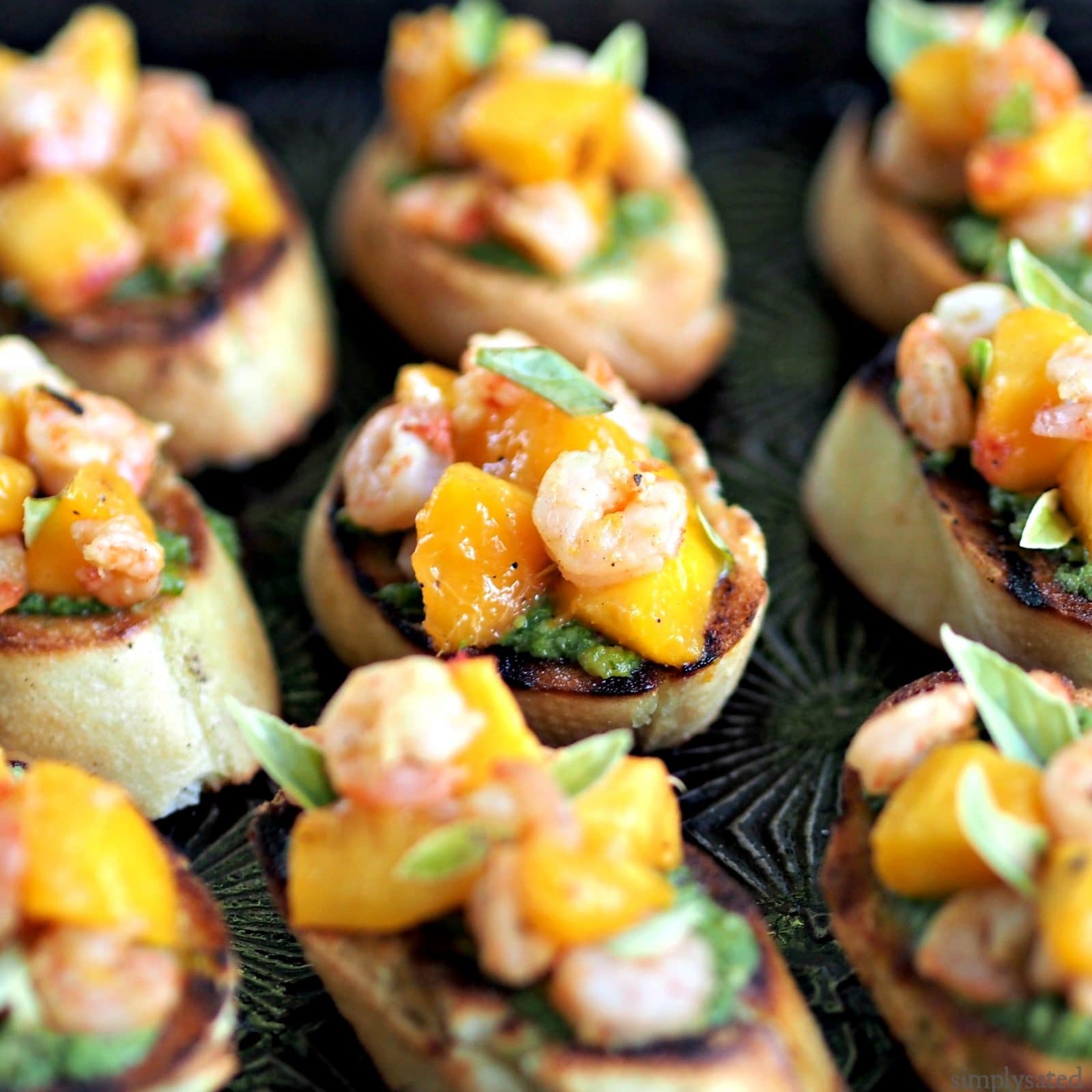 Peach & Shrimp Crostini with Pesto is an easy, elegant appetizer. Perfect for family or friends. www.simplysated.com