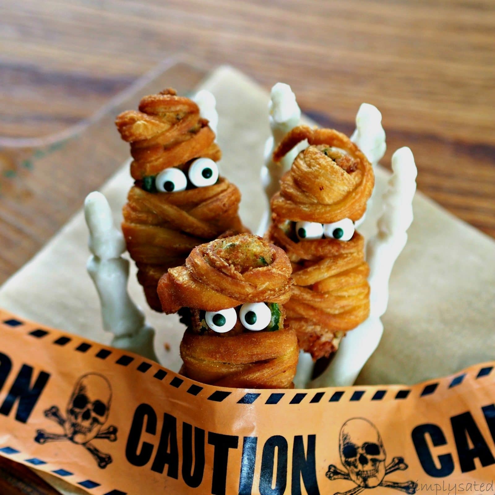 Jalapeno Popper Mummies - a little bit hot, a little bit sweet and a lot of fun. Jalapeno Popper Mummies are the perfect Halloween treat.