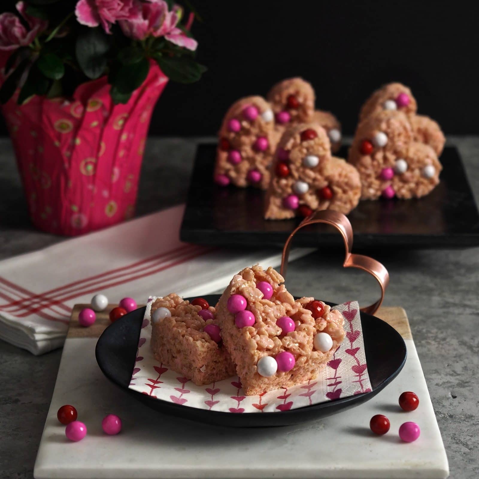 Valentine Krispie Treats made easy using strawberry heart marshmallows, garnished with your favorite candy and cut out with Valentine shaped cookie cutters. Simply Sated