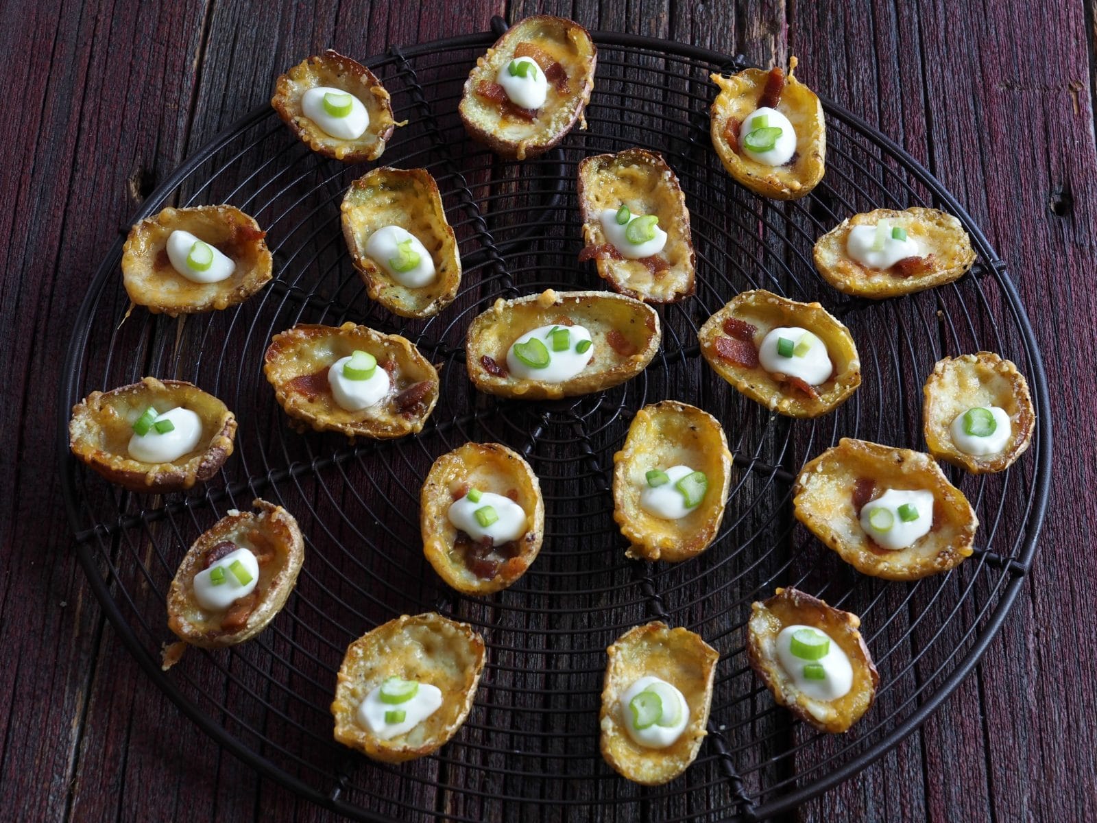 Three-Cheese Mini Potato Skins. The perfect bite-size appetizers. Mini potato skins loaded with three cheeses, bacon, sour cream and green onions. simply sated