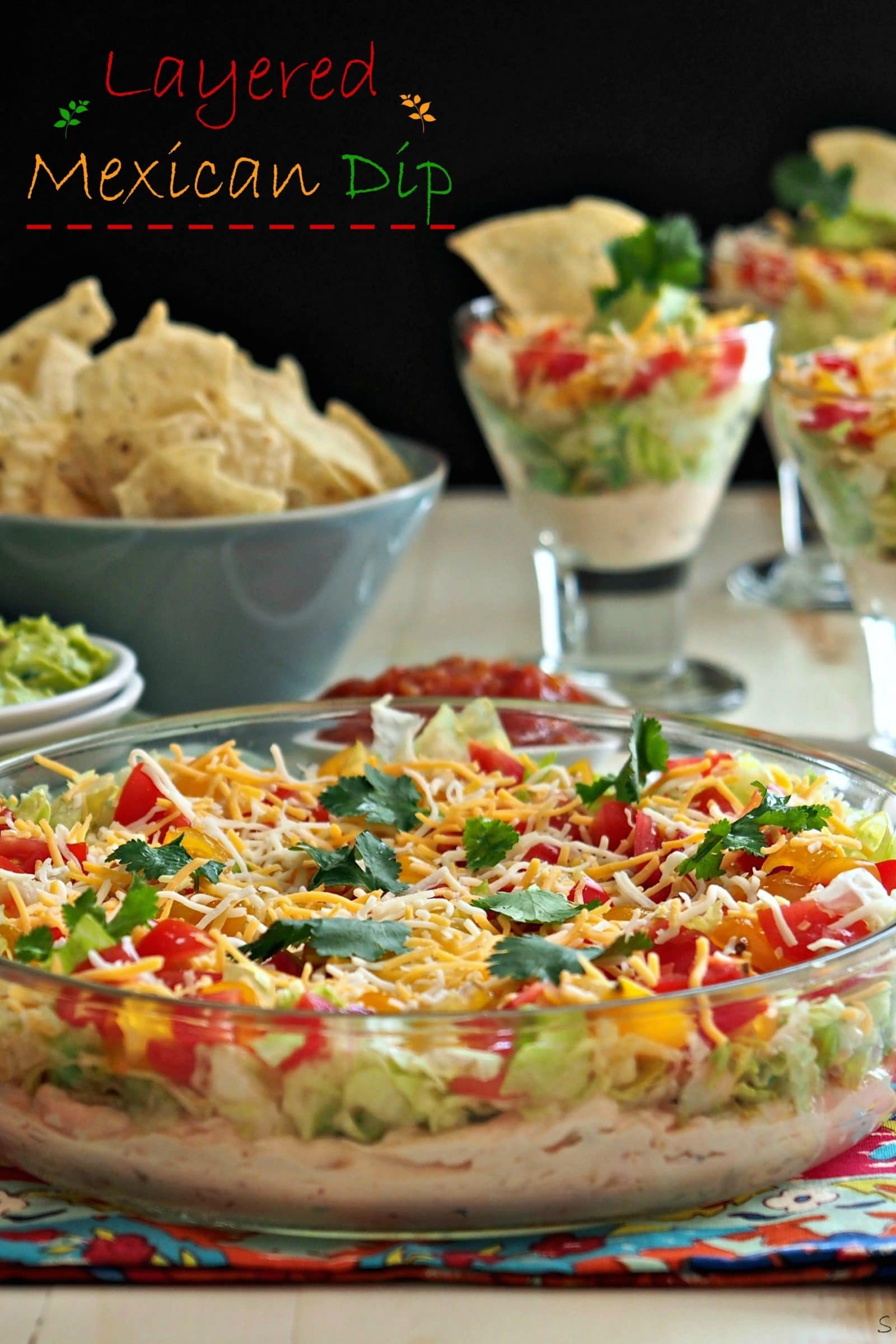 Layered Mexican Dip is as cozy as a patchwork quilt. It is an all-time favorite in its simplest form. Cream cheese, salsa, cheese, lettuce & tomatoes. Simply Sated