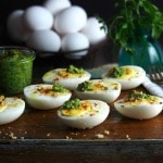 Pesto on Eggs topped with Sugared Pecans is a delicious and beautiful way to serve hard-cooked eggs. Pesto, eggs, smoked paprika, sugared pecans & Panko. Simply Sated