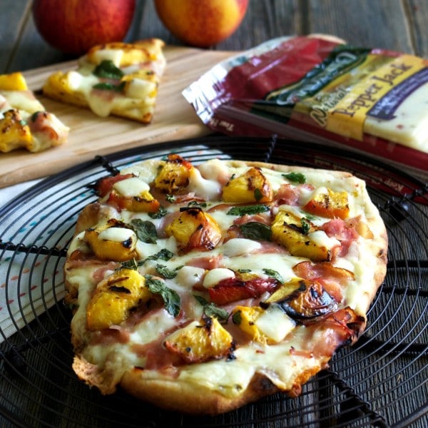 Grilled Peach & Pepper Jack Pizza (EASY) flatbread topped with Sargento Pepper Jack & Provolone Cheese slices, grilled peaches, deli ham, basil & honey. Simply Sated