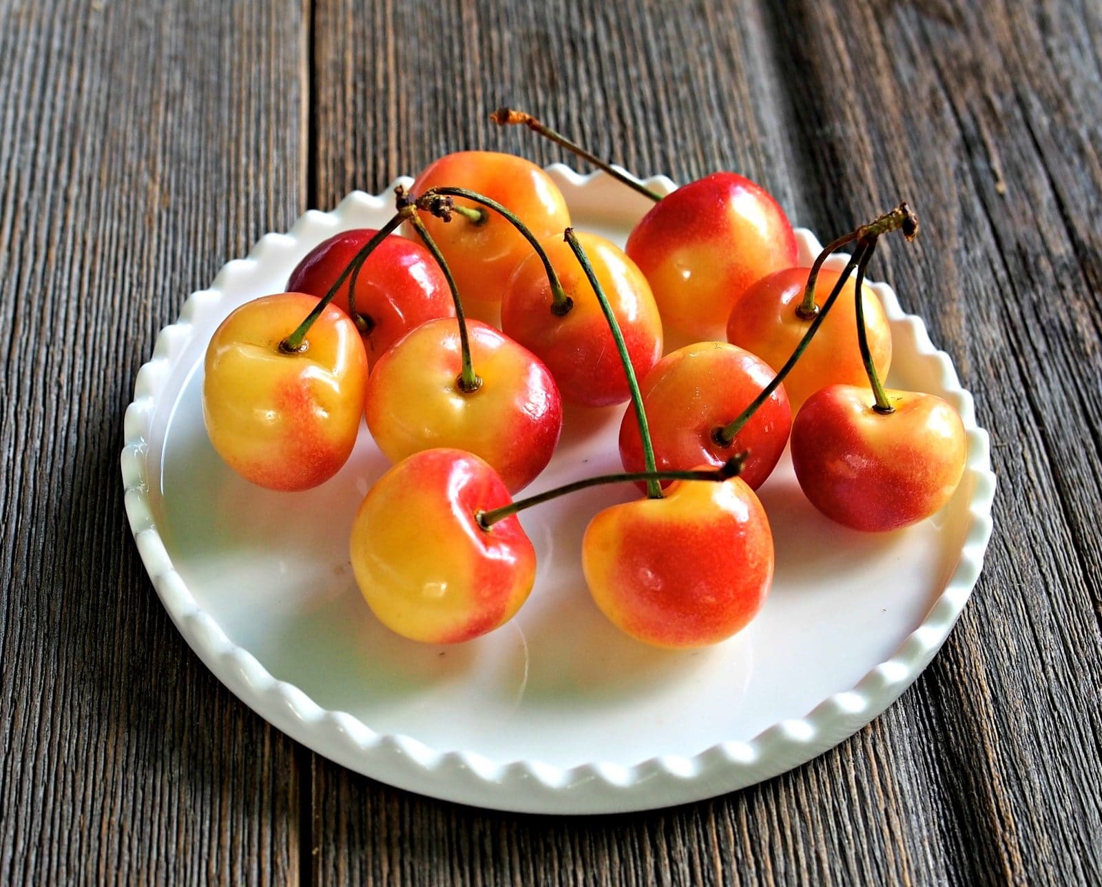 Rainier Cherry Pie Bites -deconstructed cherry pie bites. Sweet, juicy, cinnamon-y, lovely bites made with uncooked cherries & drizzled with almond honey. Simply Sated