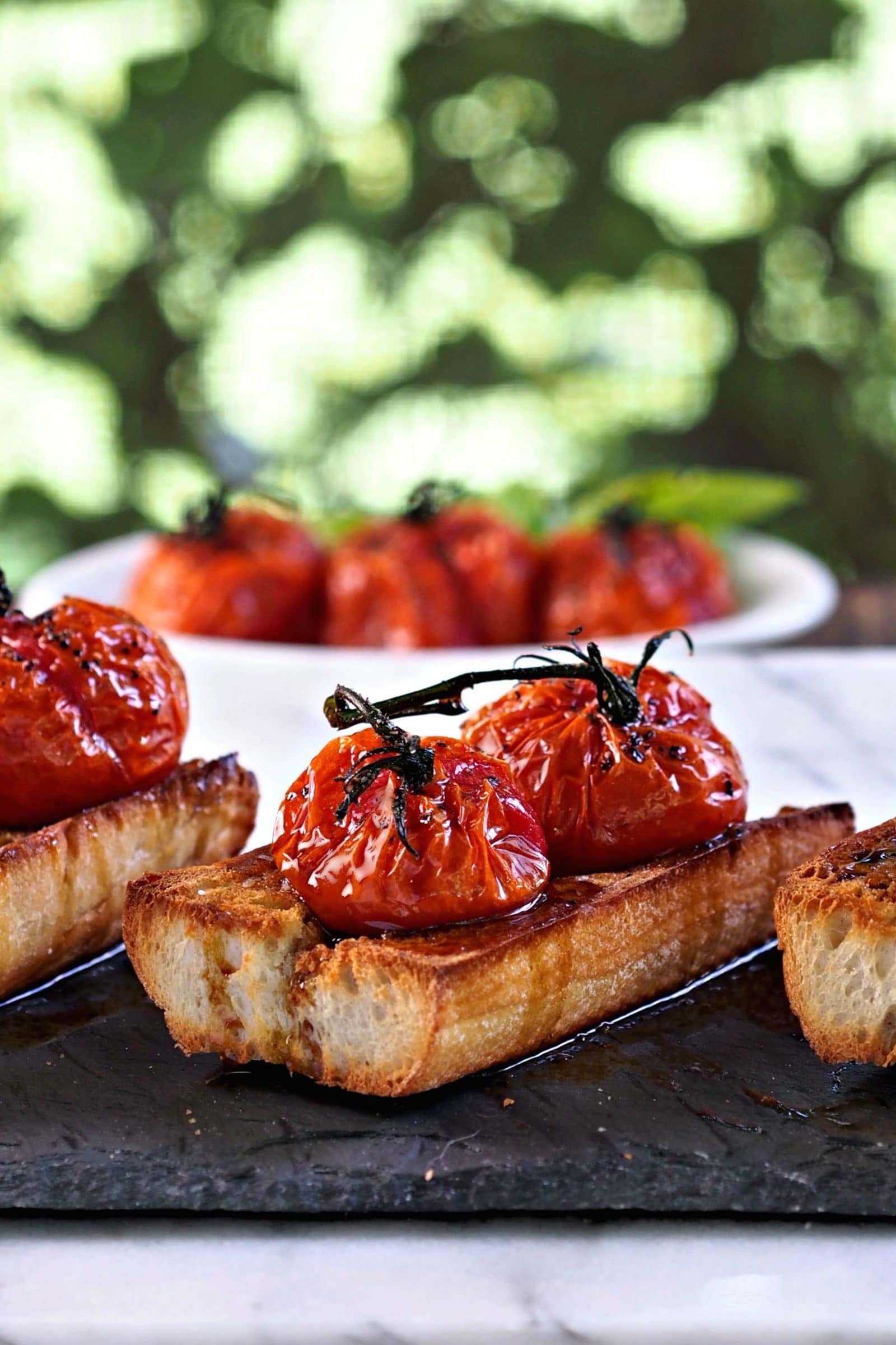 Roasted Tomato Bruschetta. Toasted Italian bread topped w/roasted tomatoes on the vine - the perfect appetizer for your favorite Italian meal. Simply Sated
