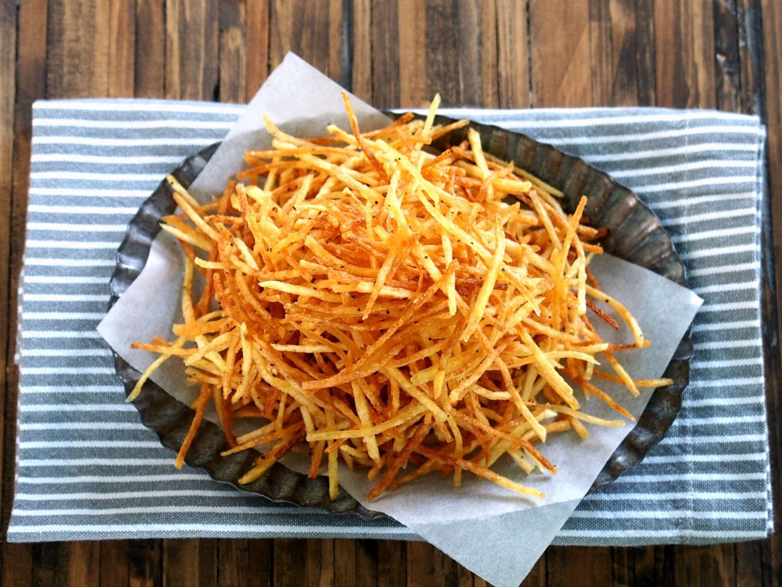 Crispy Crunchy Shoestring Potatoes. Matchstick potatoes deep-fried until golden brown then perfectly seasoned. Simple, delicious and addicting. Simply Sated
