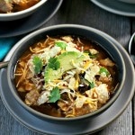 Chicken Tortilla Soup - chicken, beans, tomatoes and Mexican spices simmered together and topped with tortilla chips, cheese & sour cream. So delicious! Simply Sated