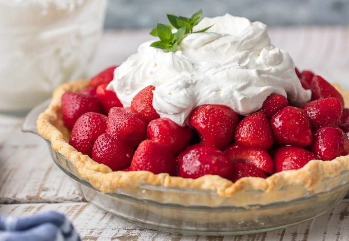 Fresh Strawberry Pie - a mound of glazed, fresh strawberries nestled in a crispy tender crust & topped with whipped cream. As beautiful as it is delicious. Simply Sated