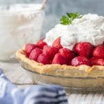 Fresh Strawberry Pie - a mound of glazed, fresh strawberries nestled in a crispy tender crust & topped with whipped cream. As beautiful as it is delicious. Simply Sated