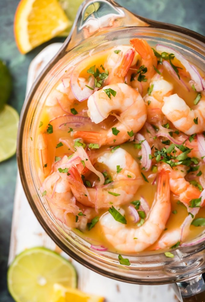 Secret Ingredient Shrimp Cocktail (Ceviche de Camaron) is made by marinating cooked shrimp in citrus juices and adding onion, jalapenos, ketchup and a few other ingredients. The secret ingredient in this shrimp cocktail is using orange & lime juices which results in the best shrimp cocktail - anywhere. Enjoy! Simply Sated
