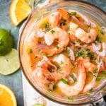 Secret Ingredient Shrimp Cocktail (Ceviche de Camaron) is made by marinating cooked shrimp in citrus juices and adding onion, jalapenos, ketchup and a few other ingredients. The secret ingredient in this shrimp cocktail is using orange & lime juices which results in the best shrimp cocktail - anywhere. Enjoy! Simply Sated