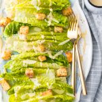 Classic Caesar Salad - there is so much to love. Crispy and leafy romaine lettuce, freshly shredded Parmigiano-Reggiano cheese & freshly ground black pepper, Homemade Garlic Parmesan Croutons drizzled with a creamy, umami-flavored dressing. This is the ultimate Classic Caesar Salad. Simply Sated