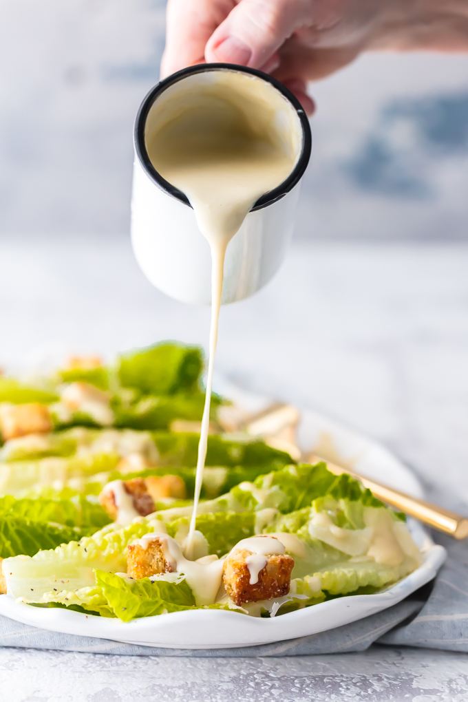 Classic Caesar Salad - there is so much to love. Crispy and leafy romaine lettuce, freshly shredded Parmigiano-Reggiano cheese & freshly ground black pepper, Homemade Garlic Parmesan Croutons drizzled with a creamy, umami-flavored dressing. This is the ultimate Classic Caesar Salad. Simply Sated