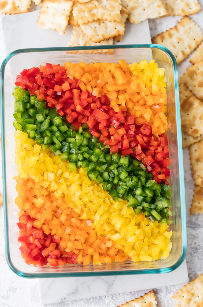 Rainbow Pepper Hummus Dip is tasty and gorgeous. It's also described with a 7-letter word...HEALTHY! It's a dip veggie-lovers love! It's a dip veggie-haters love! It's a dip children love, and it's a dip that will make you adored by the masses. So, join the Rainbow Pepper Hummus Dip party and you will be loved by all. Simply Sated